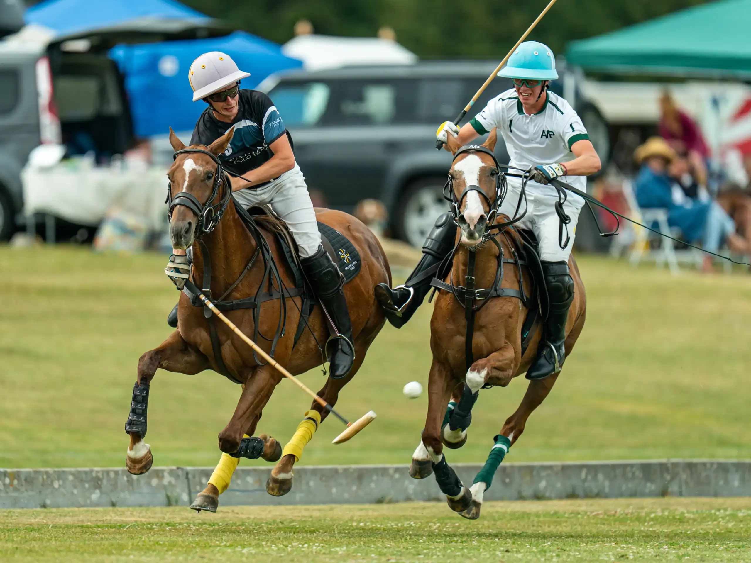 two players at the stonehenge polo festival battling for the ball