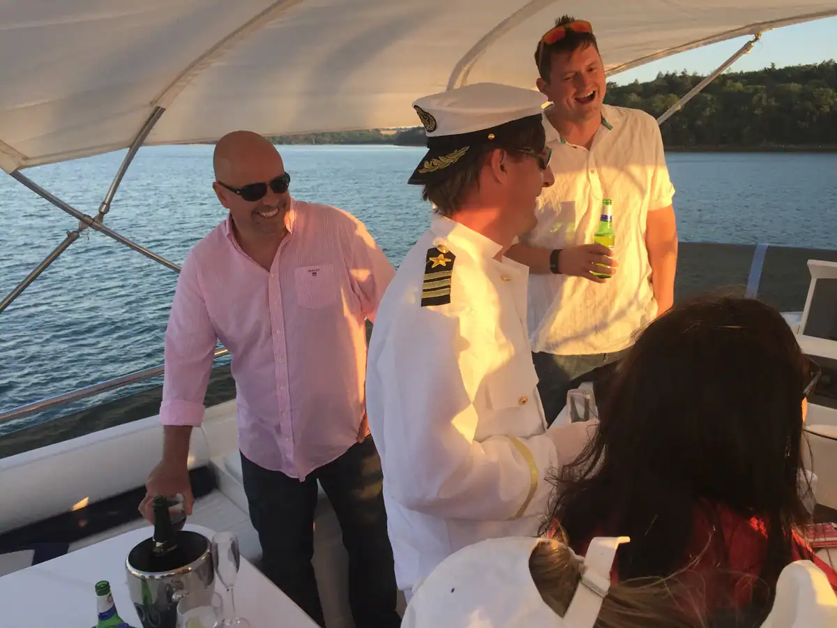 Corporate guests enjoying sundowners before the fireworks start at cowes week on board the princess powerboat
