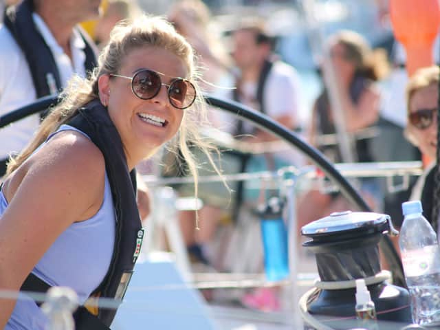 client with big smile at a sailing event&nbsp;