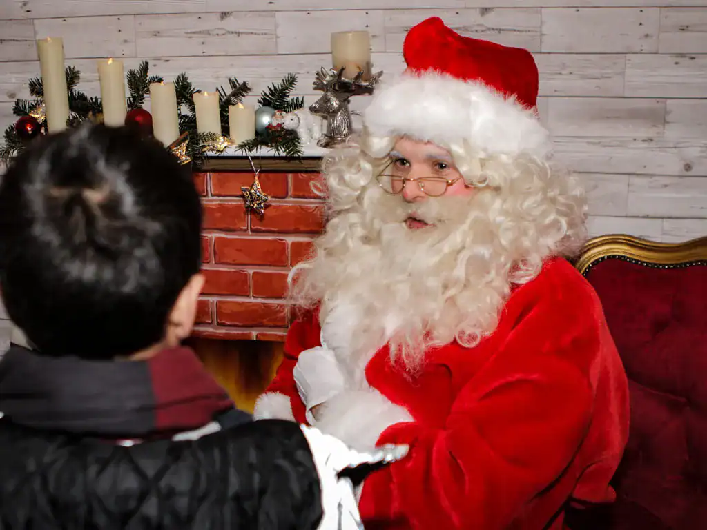 Santa giving gifts to the families at the Christmas family fun day event