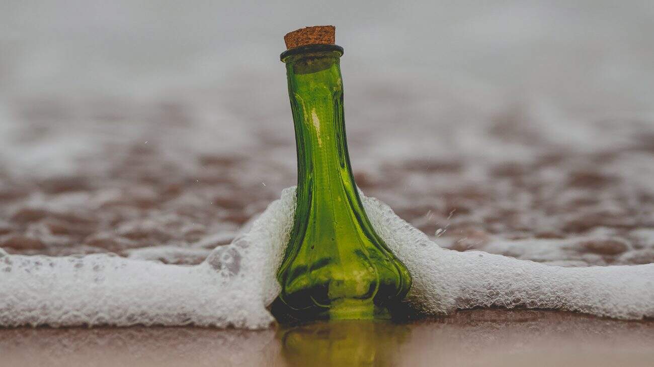 message in bottle on seashore