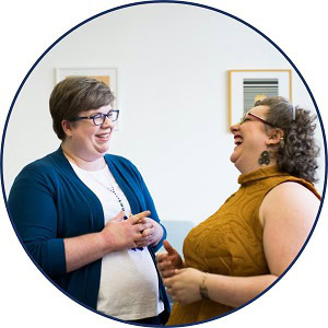 Two people stood talking and laughing