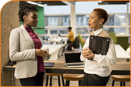 Two people stood in an office having a conversation