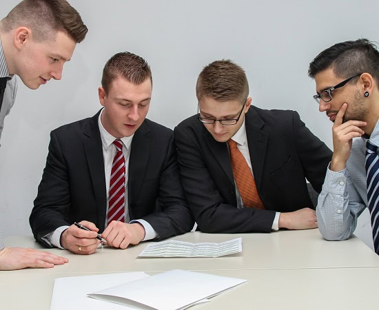 People sat around a table looking at documents