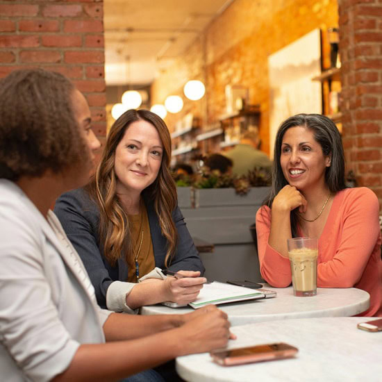 Three people sat around a table