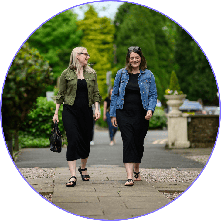 Two people walking on a path 