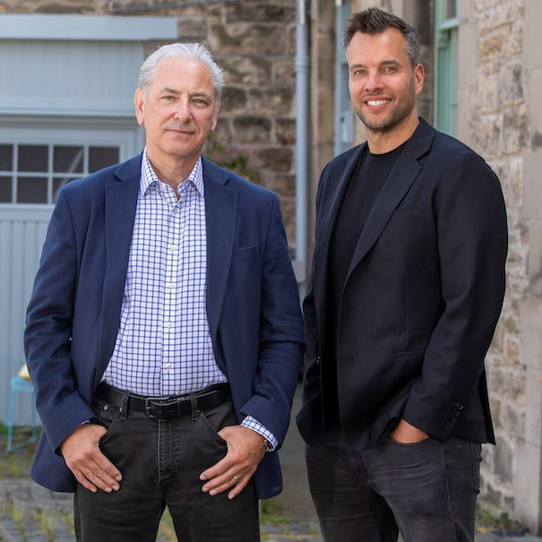 Two men standing outside